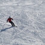 Person skiing down a mountain covered in snow