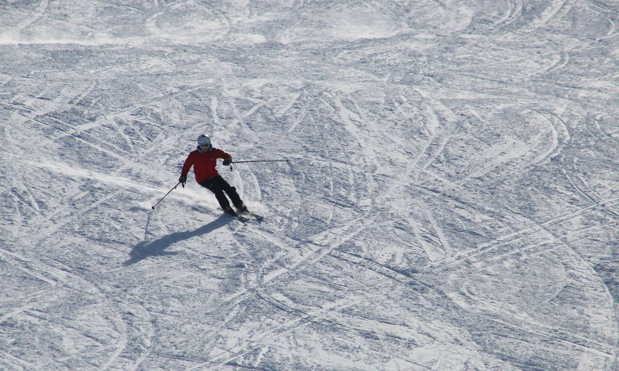 Person skiing down a mountain covered in snow