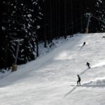 3 skiers going down the mountain